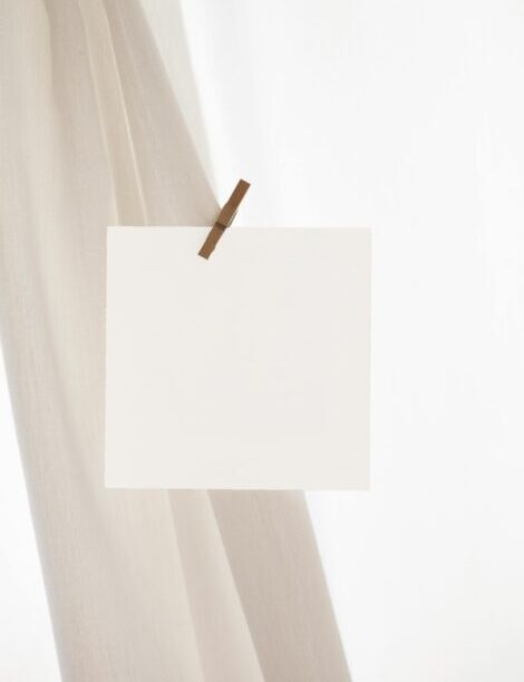 Simple blank card clipped to fabric, ideal for mockup designs with ample copy space.